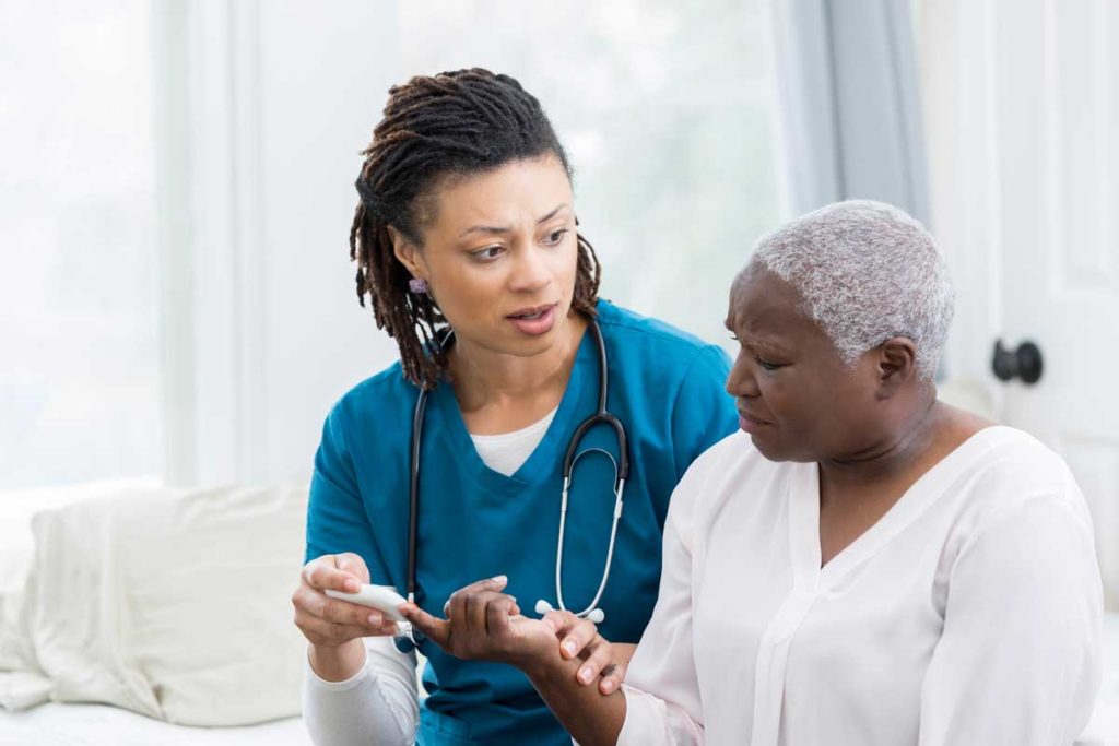 Nurse testing the diabetic patient