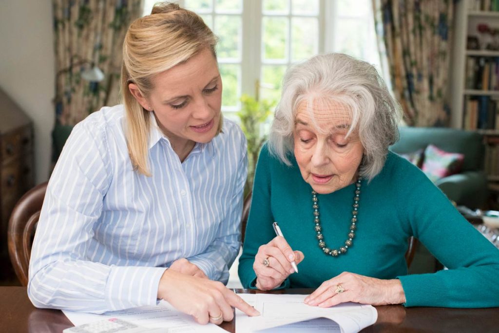 Elderly woman talking with lawyer