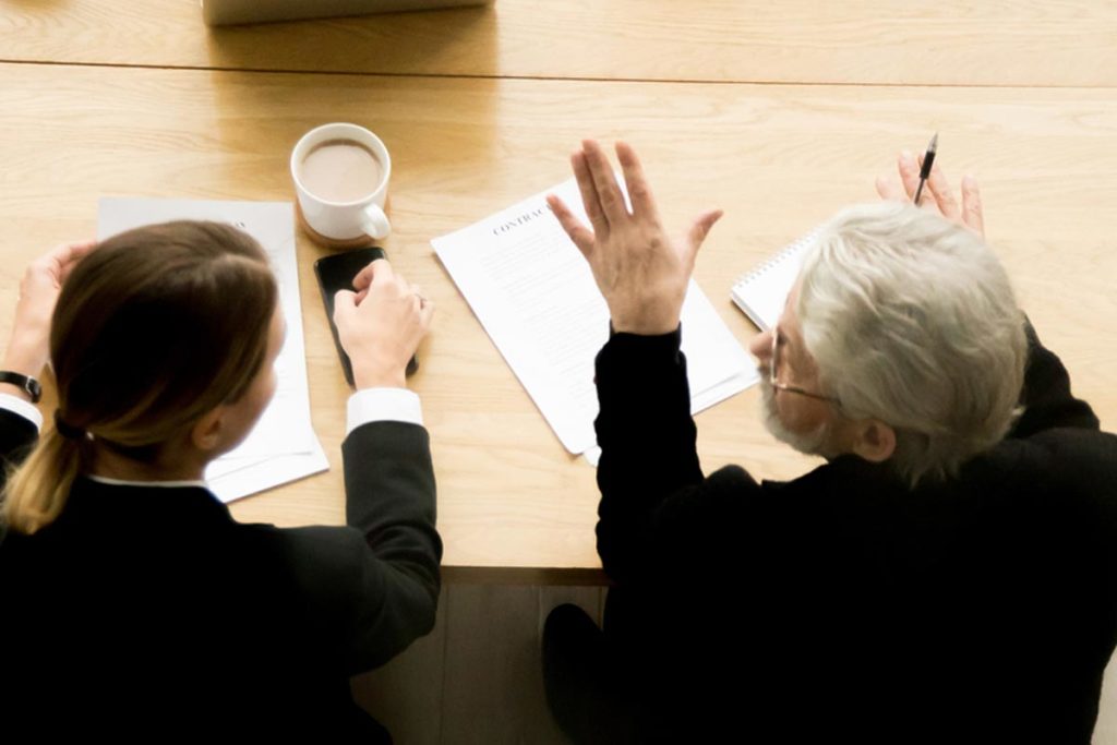 Woman and elderly senior discuss things