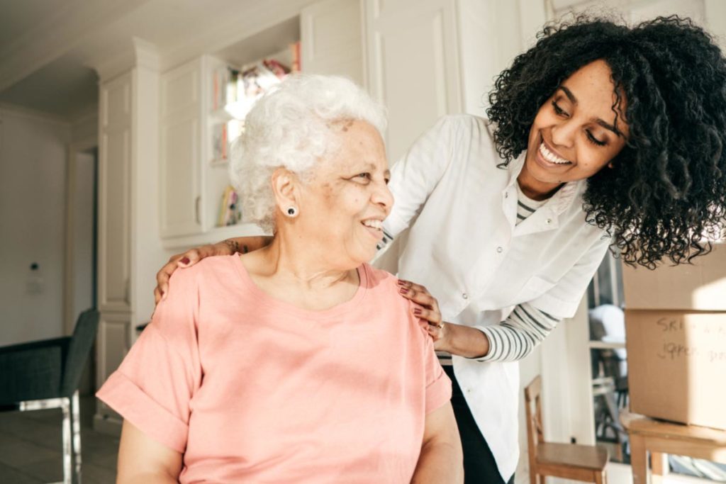 Elderly woman with nurse home caretaker