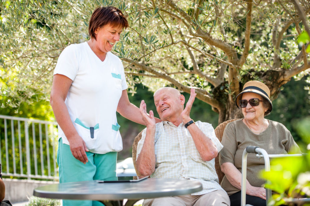 Senior Couple Having Fun With The Nurse In The Nursing Home