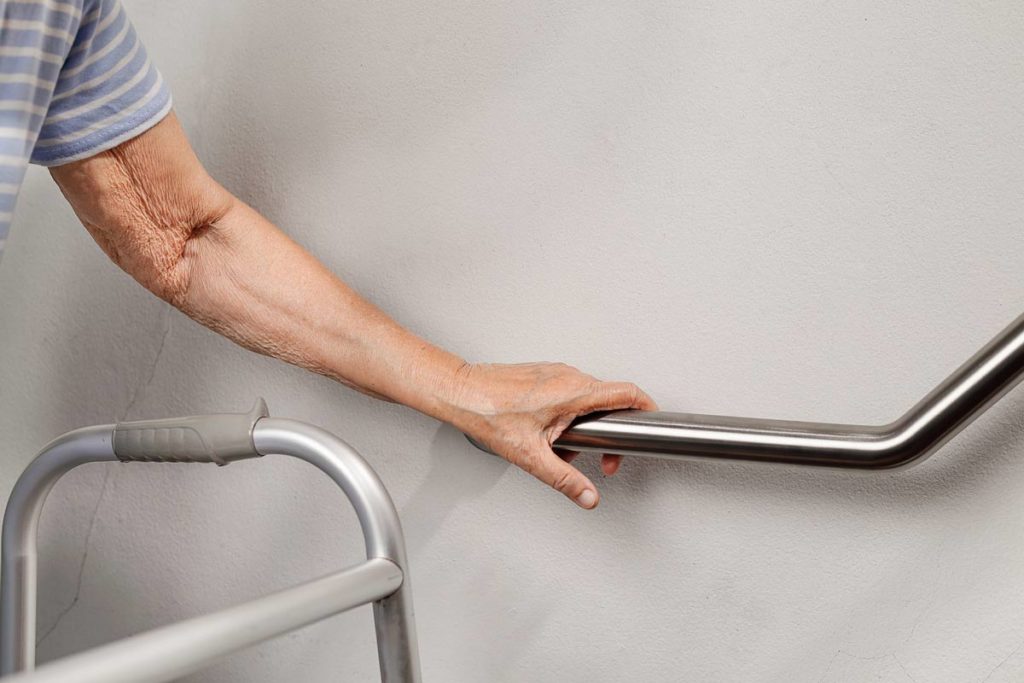 senior holding onto grab bar