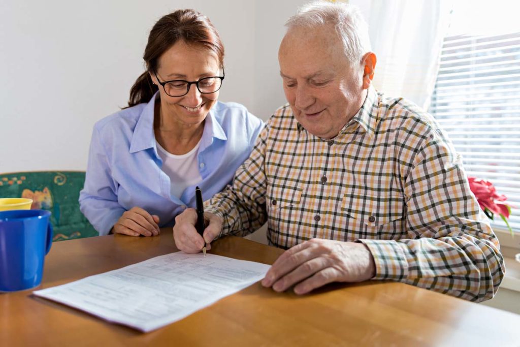 Lady with senior making notes