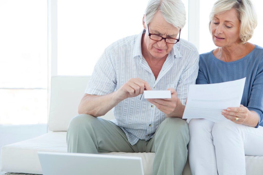 Elderly couple calculating