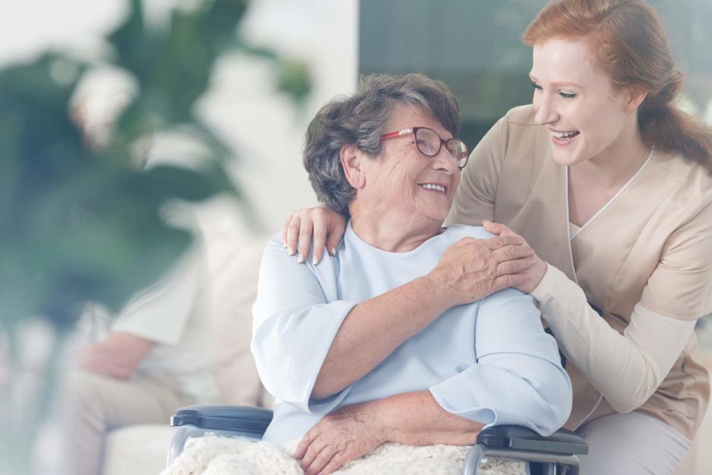 Elderly woman talking to nurse