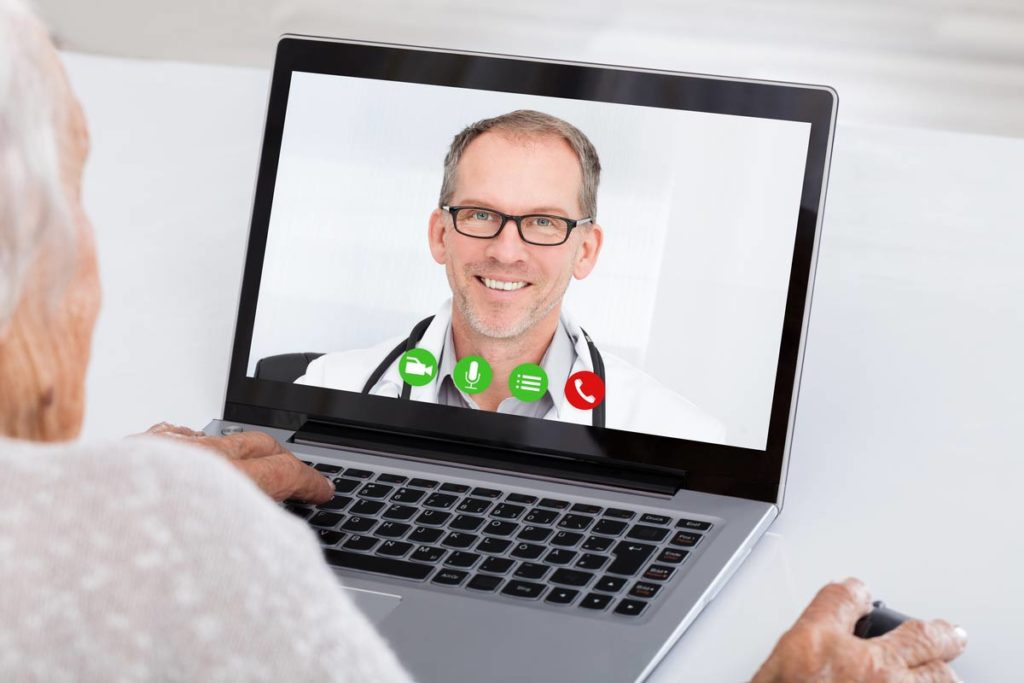 Elderly woman Skyping doctor