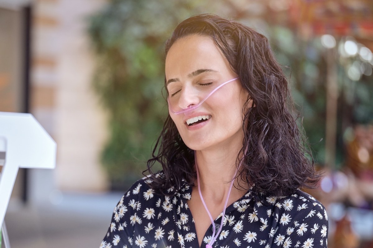 Woman Using Portable Oxygen Concentrator