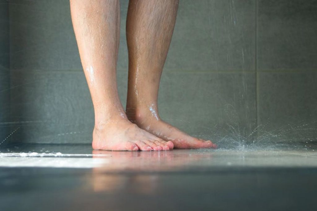 person standing in wet shower