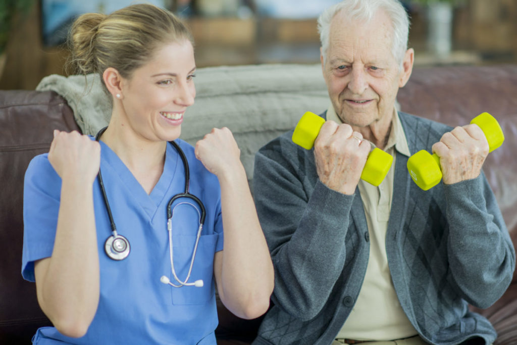 A Caucasian female nurse and elderly Caucasian man