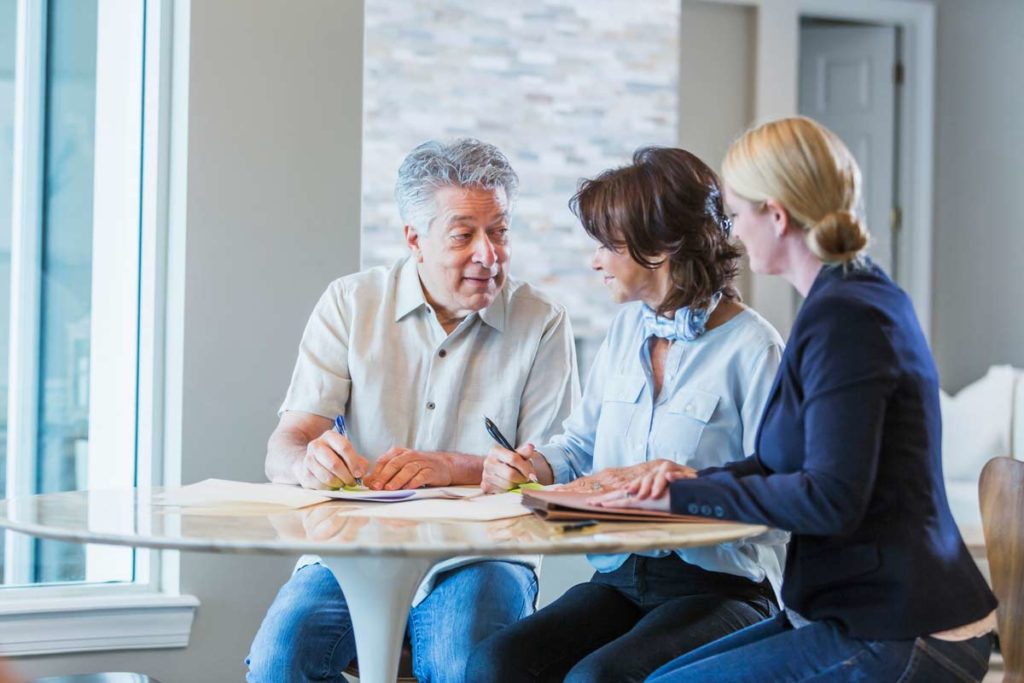 couple meeting with lawyer filling out paperwork