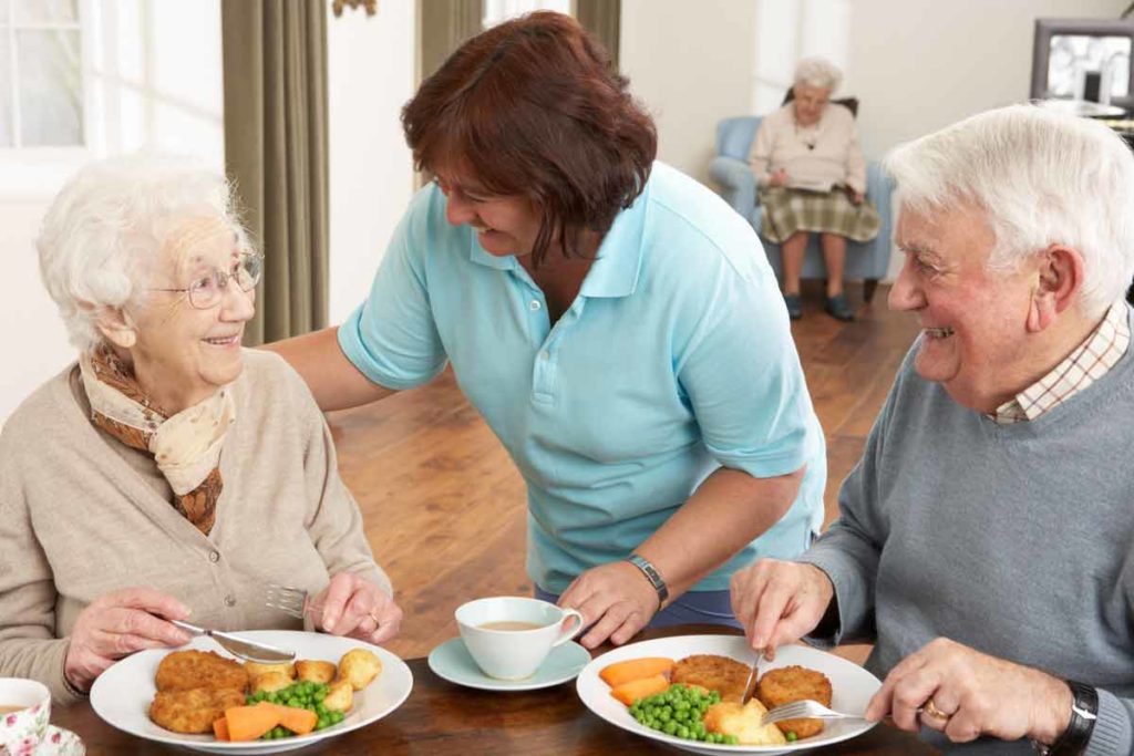 couple eating meal provided by caregiver