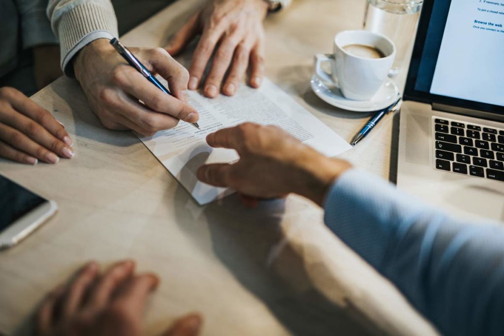 elderly woman signing paper work