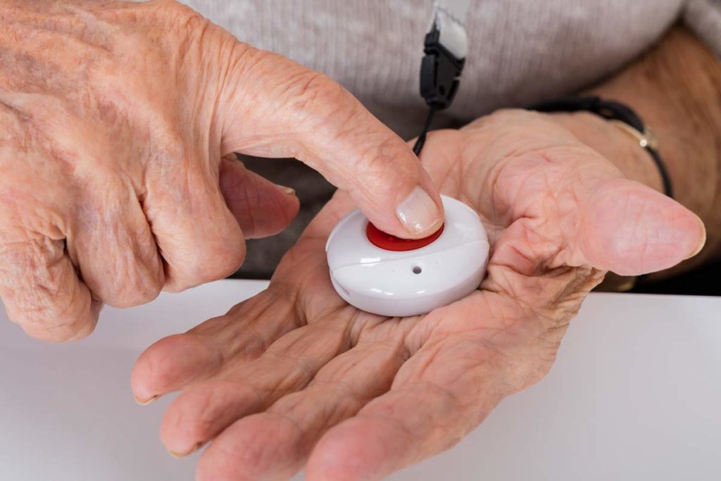 woman pushing a person emergency response system button