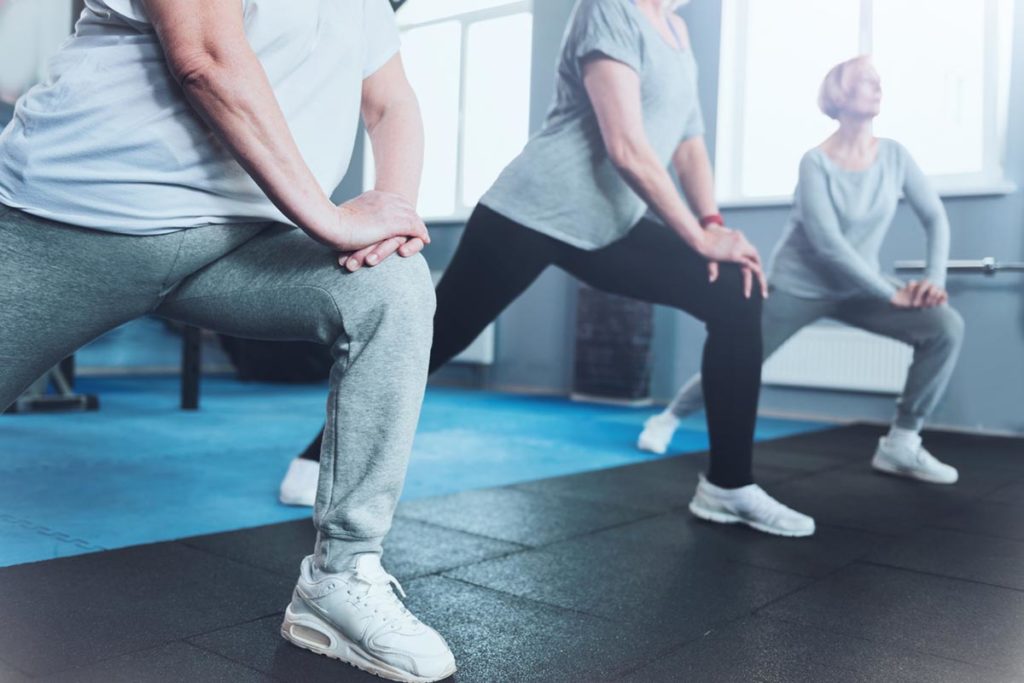 Close up look on retired women lunging at fitness club