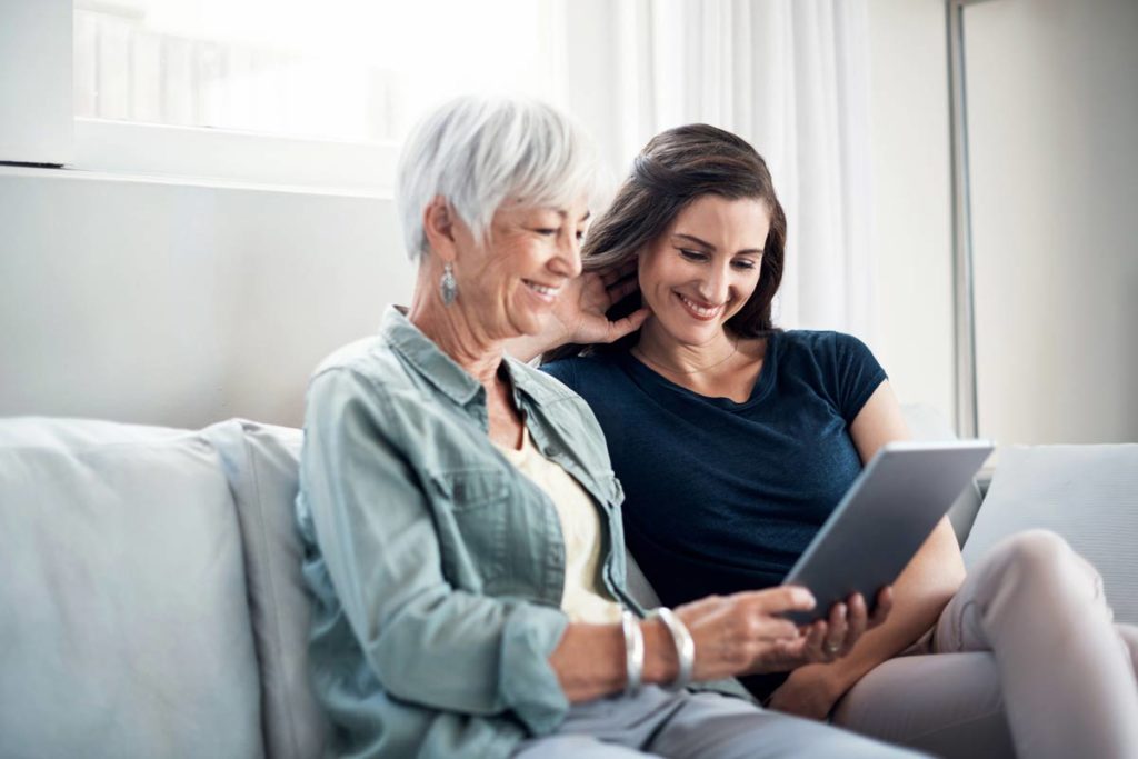 daughter spending time with mother on couch