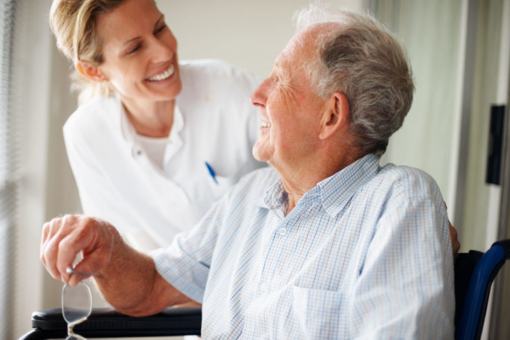 Elderly man speaking to a nurse