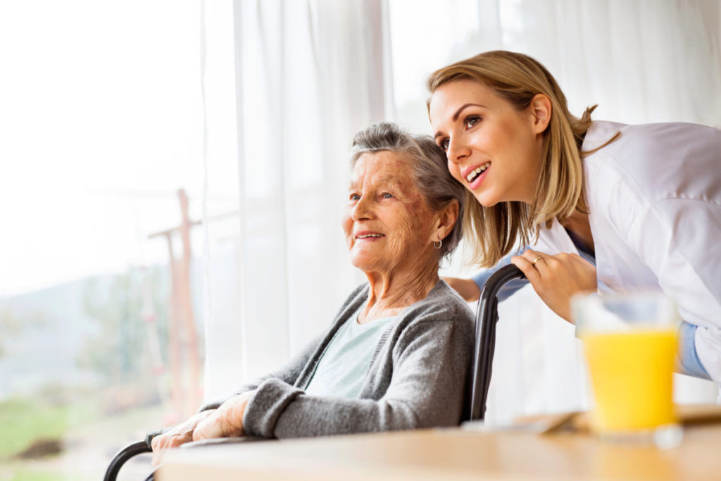 Caucasian female nurse assisting Caucasian female nurse