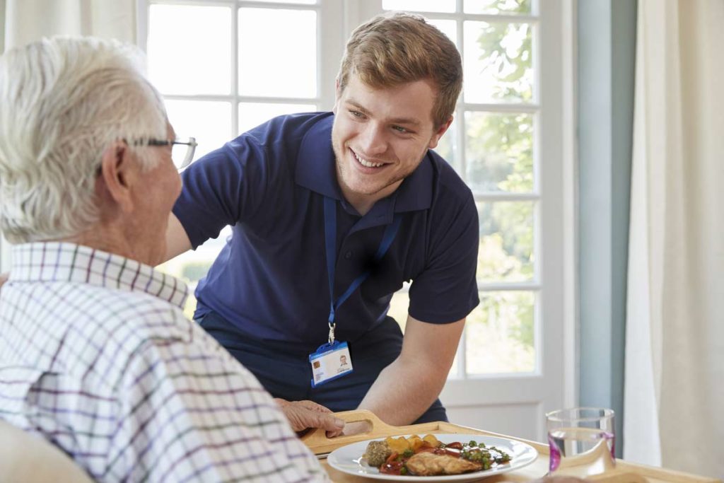 nurse serving older man