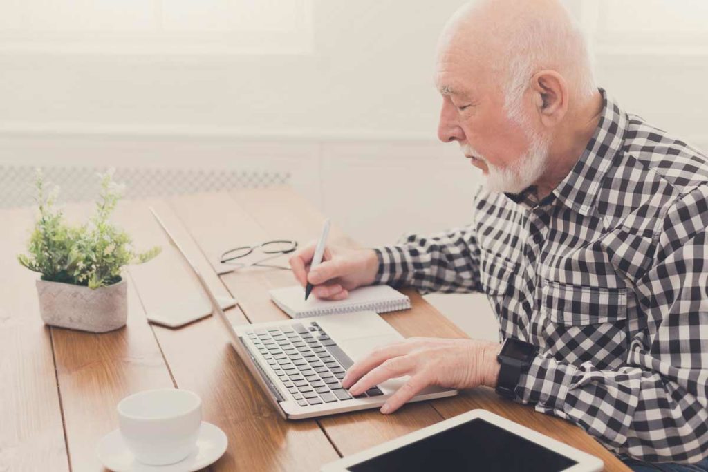 old man making notes