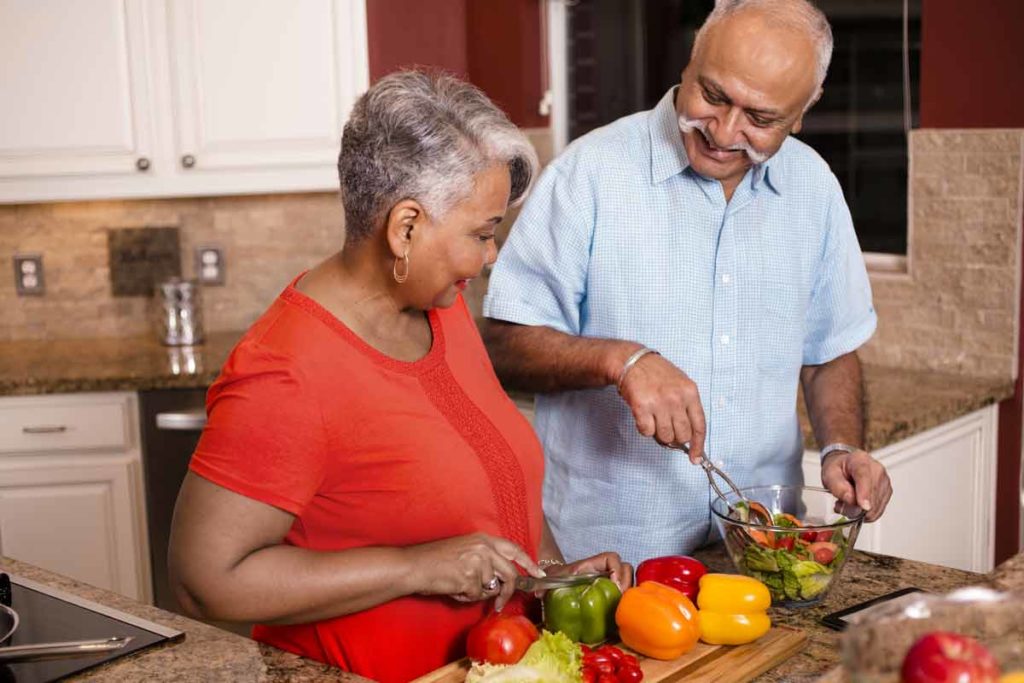 senior couple making salad