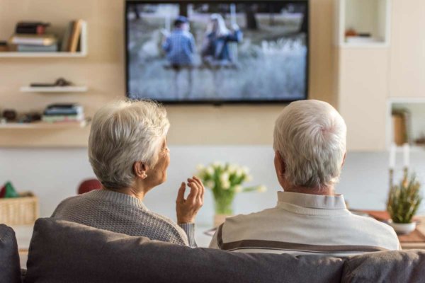 senior couple watching tv