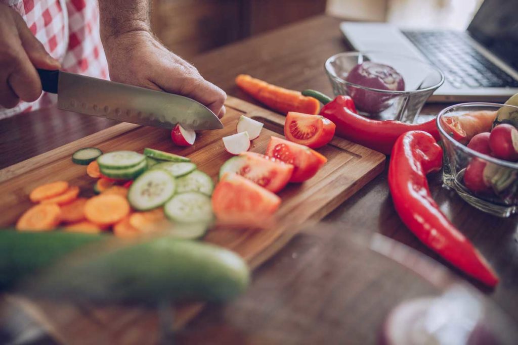 senior man cutting veggies