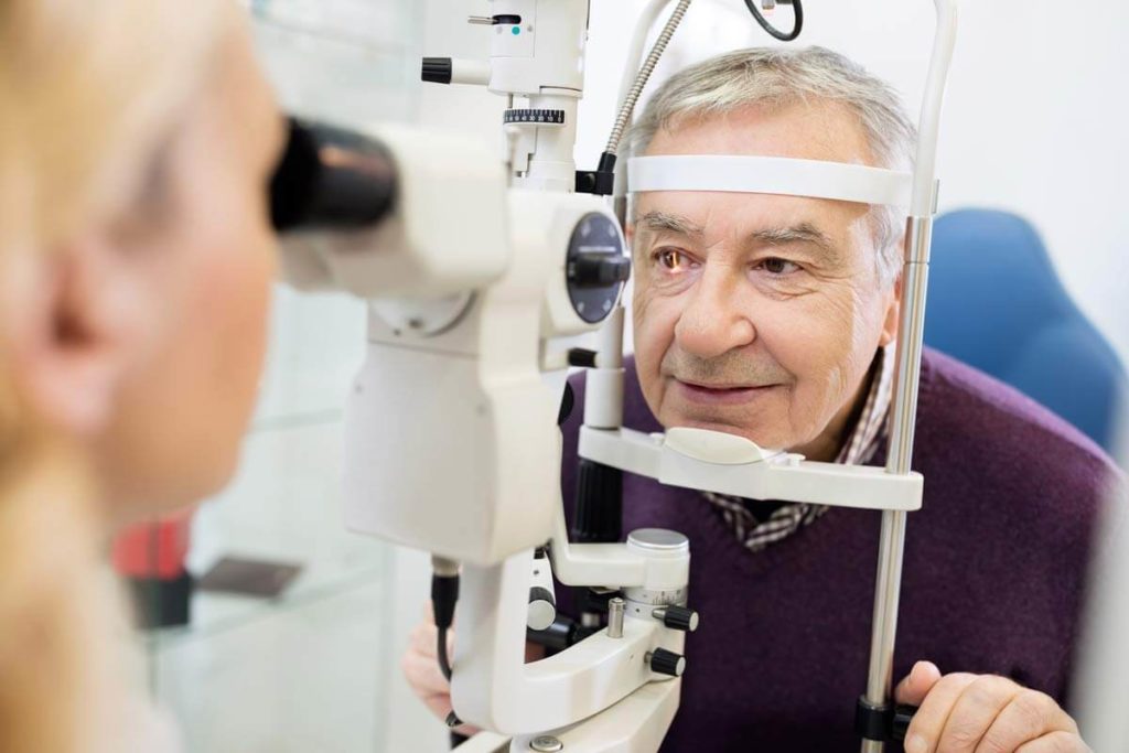 senior man getting checked for glacoma at the eye doctor