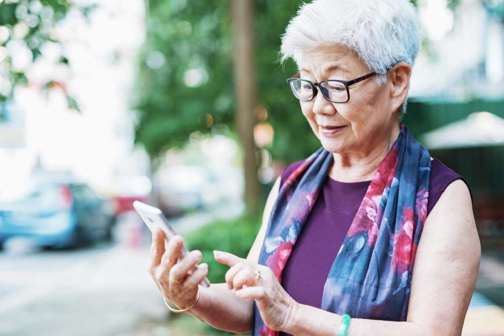 senior woman searching on smartphone