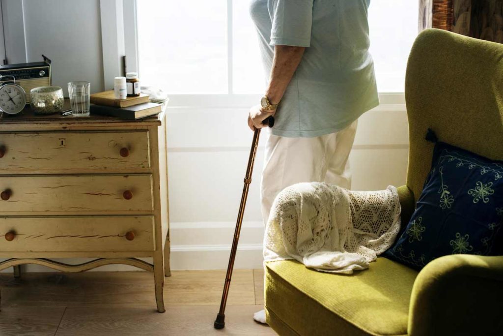 senior woman standing alone in a room