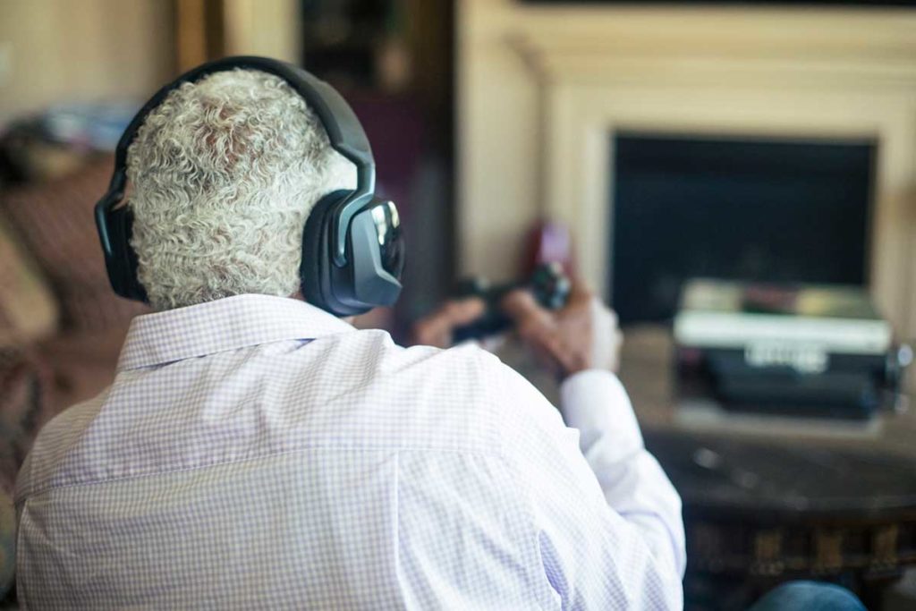 senior man playing video games