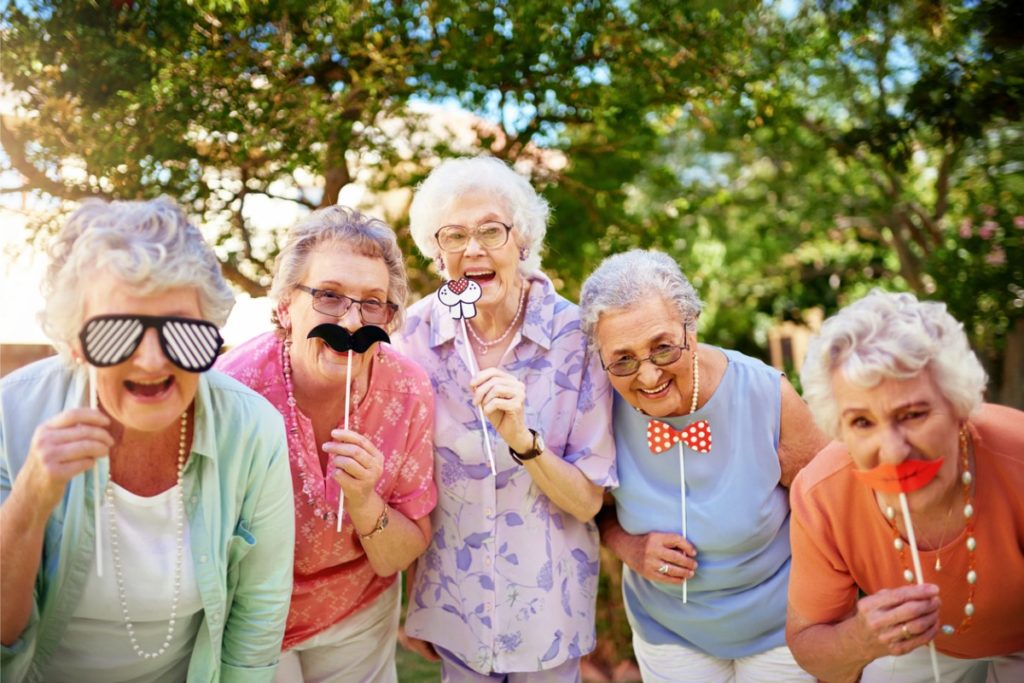 senior friends messing around outdoors