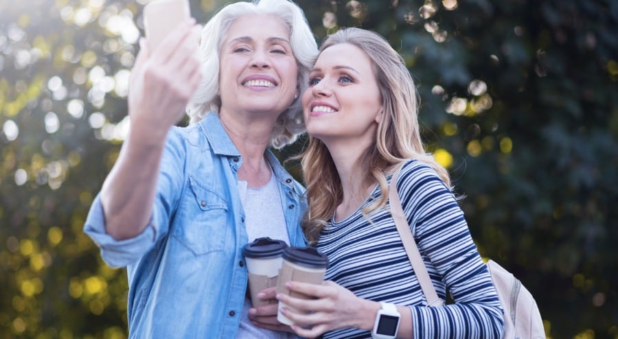 Elder Woman taking Selfie with Pregnant Daughter